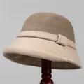 Detail of wool blend cloche hat with beige houndstooth brim on wooden stand - M (56-58cm) / Khaki