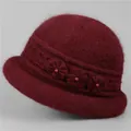 Detail of burgundy wool hat with plush texture, knitted flower and bead embellishments - Burgundy