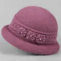 Close-up of deep purple winter knit hat featuring handcrafted flowers and pearls - Dusty Rose