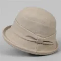 Detail of elegant beige cloche hat with a decorative bow and wool blend texture - M (56-58cm) / Beige