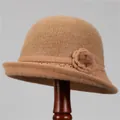 Detail of camel knitted bucket hat featuring a plush crown and floral accent with small fur ball - M (56-58cm) / Khaki