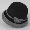 Detailed view of the wool cloche hat featuring a grey bow and stylish rolled brim detail - M (56-58cm) / Black