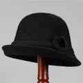 Detail of warm black knit bucket hat for elderly women with decorative plush flower accent - M (56-58cm) / Black