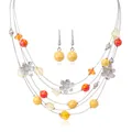 Detail of colorful beads and silver hollow flower charms on a multi-layer wire necklace set - Yellow