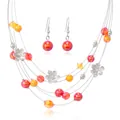 Detail of multilayer wire necklace with orange crystal beads and silver floral accents - Red
