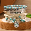 Set di 4 braccialetti bohémien con perline turchesi e ciondolo sole su legno - Collezione Bracciali Intrecciati in Pelle Scamosciata e Metallo Bohemien