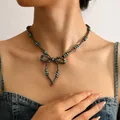 Detail of bohemian turquoise beaded necklace with double bow pendant on female model - Double Layer Bowknot Style (Style 4)