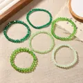 Set of 6 green faceted crystal stretch bracelets with gradient tones on linen texture - Green Style