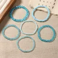 Set of six blue crystal beaded stretch bracelets featuring various faceted blue tones - Sky Blue Style