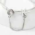 Makroaufnahme eines silbernen Schlangenarmbands mit polierten O- und K-Buchstabenanhängern - Silber