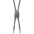 Close-up of vintage cicada bolo tie with carved metal tips and black braided cord - Antique Silver