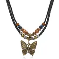 Close-up of bronze butterfly pendant with ethnic wooden beads on multilayer woven necklace - Black Cord Butterfly Pendant