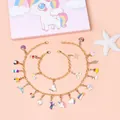 Set di due braccialetti dorati per bambini con ciondoli smaltati a forma di unicorno - Set Scatola a Sorpresa Unicorno