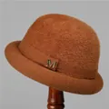 Detail of a brown knit winter hat for women with plush texture and jeweled M accessory - M (56-58cm) / Caramel color