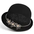 Detailed view of black cloche hat featuring rhinestone band and pearl flower accents - Black