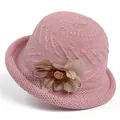 Detail of pink knitted basin hat featuring a layered fabric flower and wavy crochet texture - M / Pink