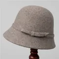 Classic retro wool cloche hat in taupe grey with a bow ribbon on a wooden stand - M (56-58cm) / Light Coffee