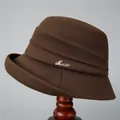 Detail of coffee brown wool bucket hat showing stylish pleated layers and rhinestone music buckle - M (56-58cm) / Coffee