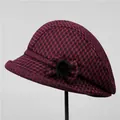 Detail of red and black plaid wool hat featuring a side bow and faux fur pom-pom - M (56-58cm) / Burgundy