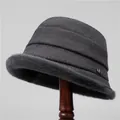 Detailed view of the dark grey wool bucket hat with plush faux fur trim and metal logo - M (56-58cm) / Gray