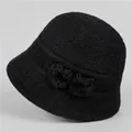 Detail of black knit bucket hat for elderly women with plush fur pompom accents - M (56-58cm) / Black