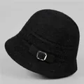 Close-up of black knit winter bucket hat featuring furry texture and silver metal buckle - M / Black