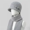 Detail of grey knitted hat with bow and pearl decor on a white mannequin head - Hats And Scarves / Gray