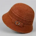 Close-up of rust red plush knit bucket hat showing fuzzy texture and silver buckle detail - M / Caramel color