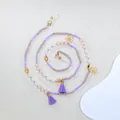 Detailopname van kralen brillenkoord met paarse kwastjes en gouden bloemen - Paarse Stijl (B) / Paars