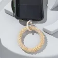 Detail of beaded phone strap with translucent champagne beads and white ring clip - Beige