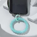 Detailed macro view showing blue beaded phone strap connected to transparent PVC patch - Lake Blue