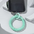 Light green glass bead phone wrist strap with metal clasp on modern white background - Green