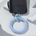 Close-up of light blue glass bead phone strap with transparent pad on white platform - Light Blue