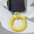 Macro shot of bright yellow beaded phone wrist strap with metal spring clasp and adapter - Bright Yellow
