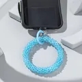 Close-up of sky blue faceted glass bead phone strap with circular connector and attachment - Dark Blue