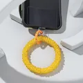 Detail of yellow beaded phone strap with orange spring ring buckle on camo phone case - Yellow