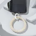 Detailed view of champagne beaded phone wristlet with white clasp and clear connector - White