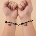 Magnetische koppelarmbanden met roze vlinderhanger en hartsluiting in zwart vlecht - Roze Paars