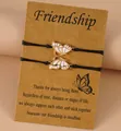 Detail of 2pcs butterfly friendship bracelets on card with black adjustable wax cords - Pink Enamel Style (Style 3-1)