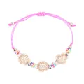 Detail of pink woven bracelet with turtle charms and colorful beads on white background - Pink