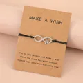 Minimalistische oneindigheid pootafdruk armband op zwart koord met een wenskaart - Zilver