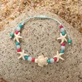 Pulsera tejida ajustable con tortuga marina, cuentas azules y estrellas de mar en arena - Estilo de Tortuga Estrella de Mar Cuentas Multicolor / Rojo