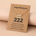 Golden necklace detail with 222 Angel Number pendant on a minimalist kraft paper display card - 222