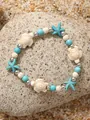 Boho oceaan armband met hemelsblauwe kralen, howliet schildpad en zeester hanger - Witte Schildpad Blauwe Kralen Stijl