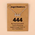 Détail du collier avec pendentif chiffre ange 444 présenté sur une carte en papier kraft - 444