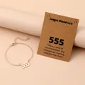 Detail of gold angel number 555 bracelet with lobster clasp and original card packaging - Number 555 / Gold