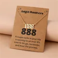 Detailed view of golden 888 angel number pendant on a decorative kraft paper card - 888