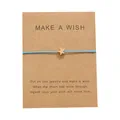 Handgefertigtes Make a Wish Armband mit blauer Kordel und goldenem Stern auf Karte - Blau