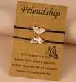 Pink enamel butterfly friendship bracelet set with black woven cord on card - Pink Enamel Style (Style 3-1)