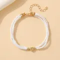 Bracelet double couche en perles blanches avec pendentif cœur doré et fermoir mousqueton - Bracelet double couche cœur blanc